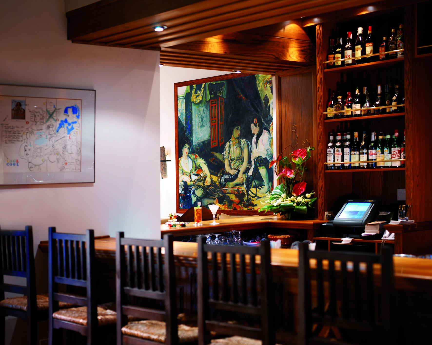 La Residencia Mallorca bar stools wine bottles large painting of three women