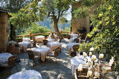 La Residencia Mallorca restaurant terrace dining area candelabras greenery trees