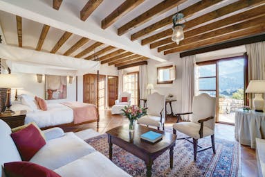 La Residencia Mallorca suite lounge area four poster bed classic modern decor mountain view