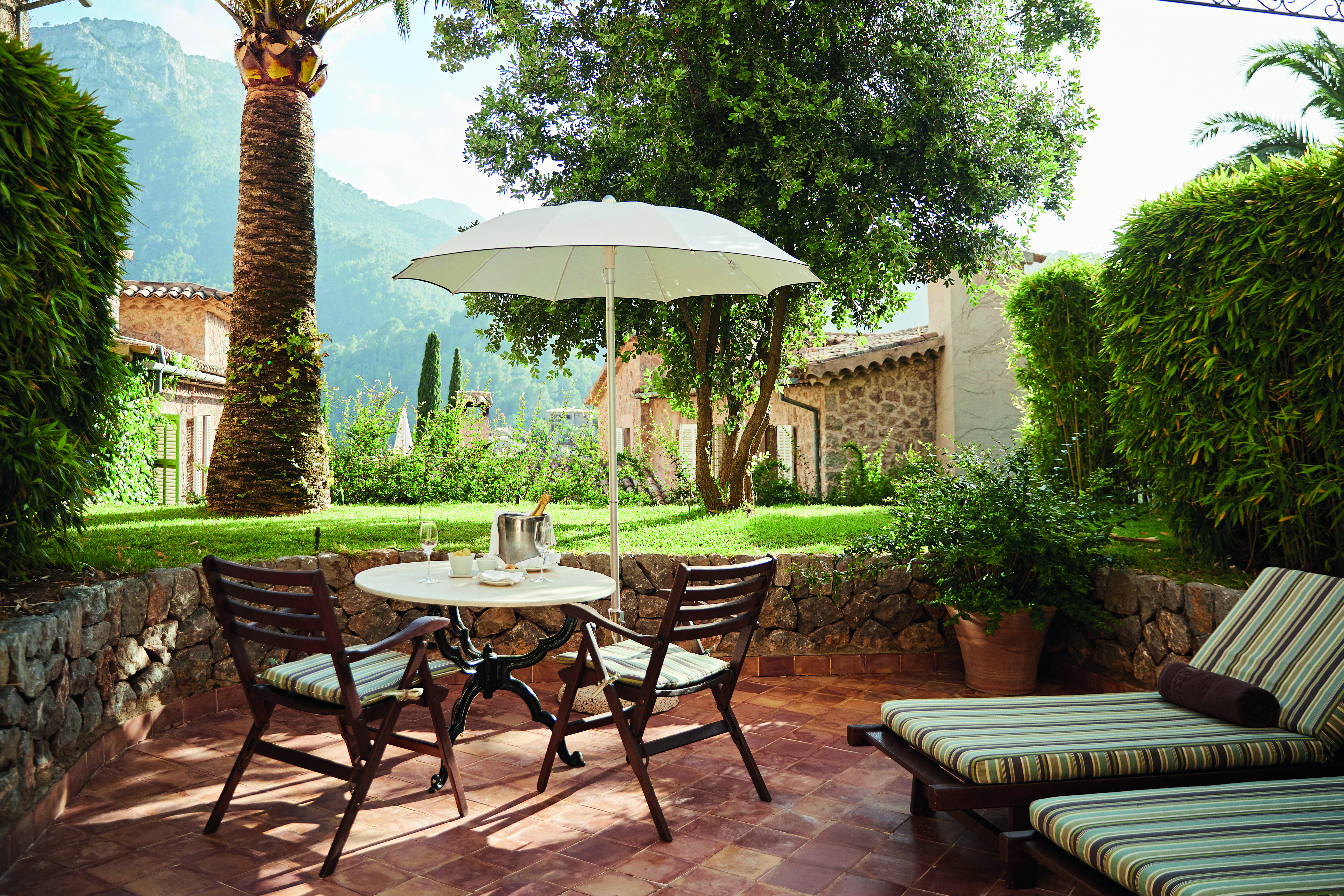 La Residencia Mallorca terrace sun loungers seating area umbrellas mountain views