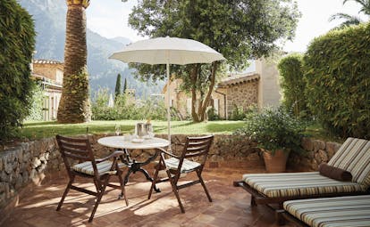 La Residencia Mallorca terrace sun loungers seating area umbrellas mountain views