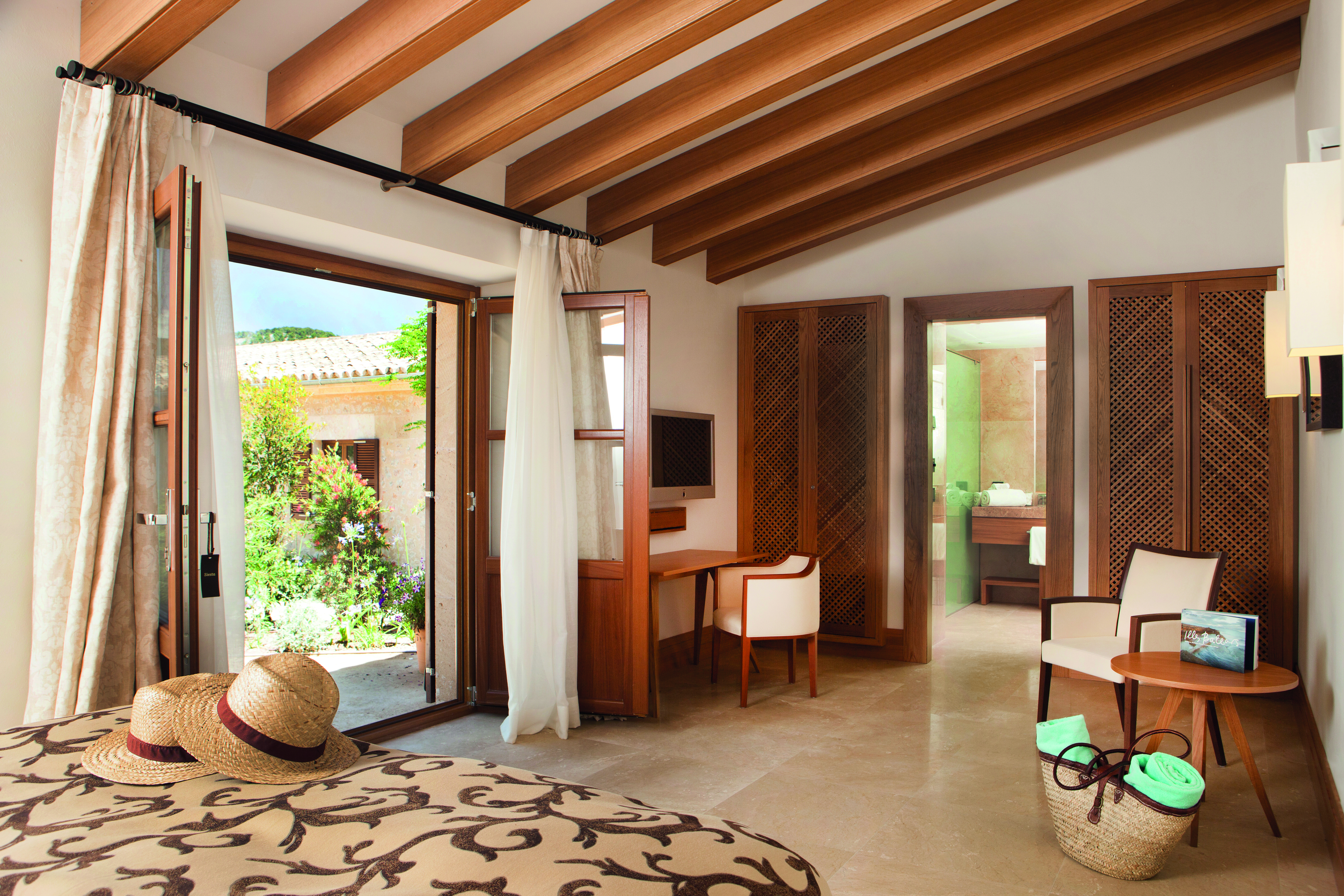 Castell Son Claret Mallorca garden suite bed en suite bathroom garden terrace modern décor
