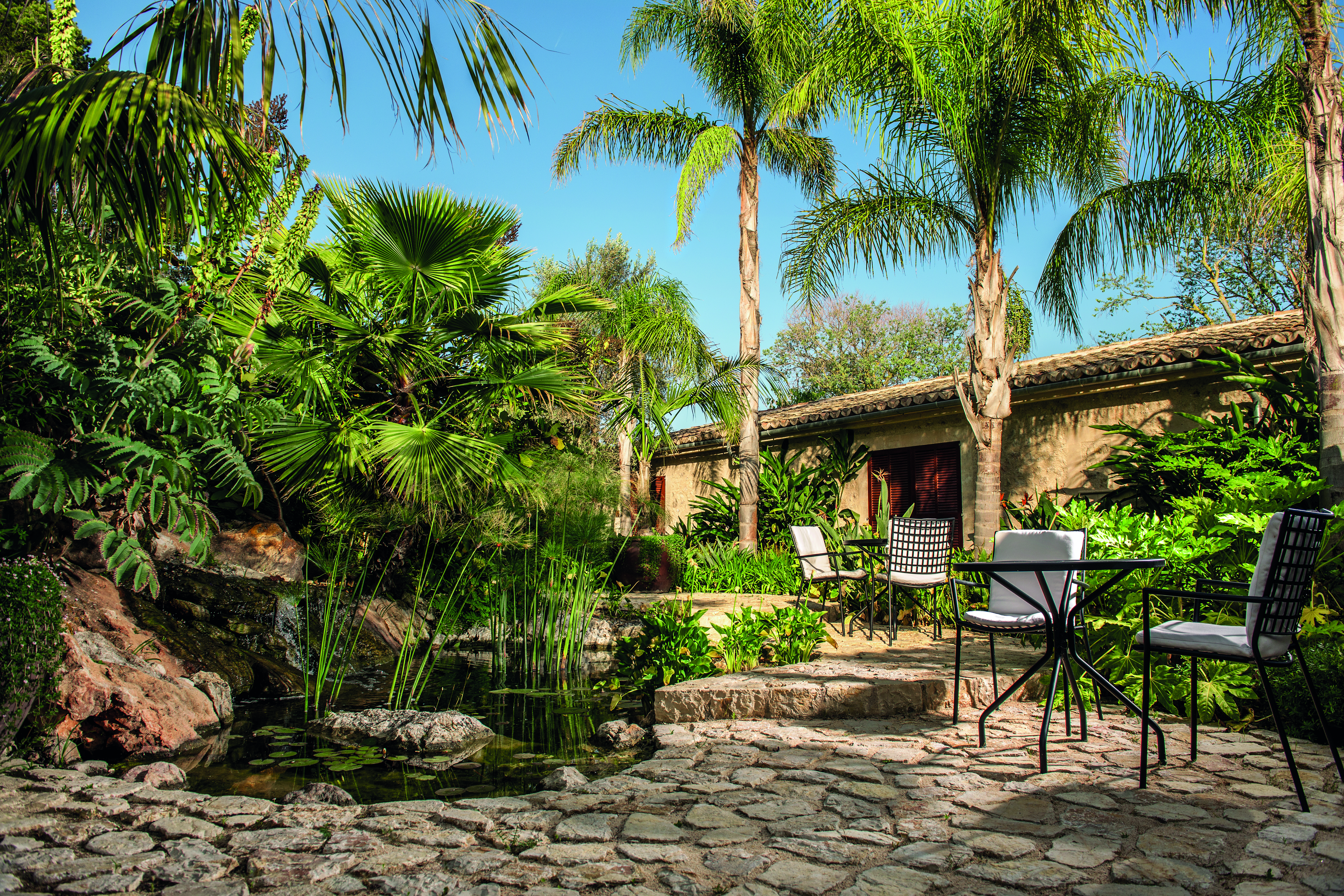 Castell Son Claret Mallorca patio outdoor seating area trees greenery