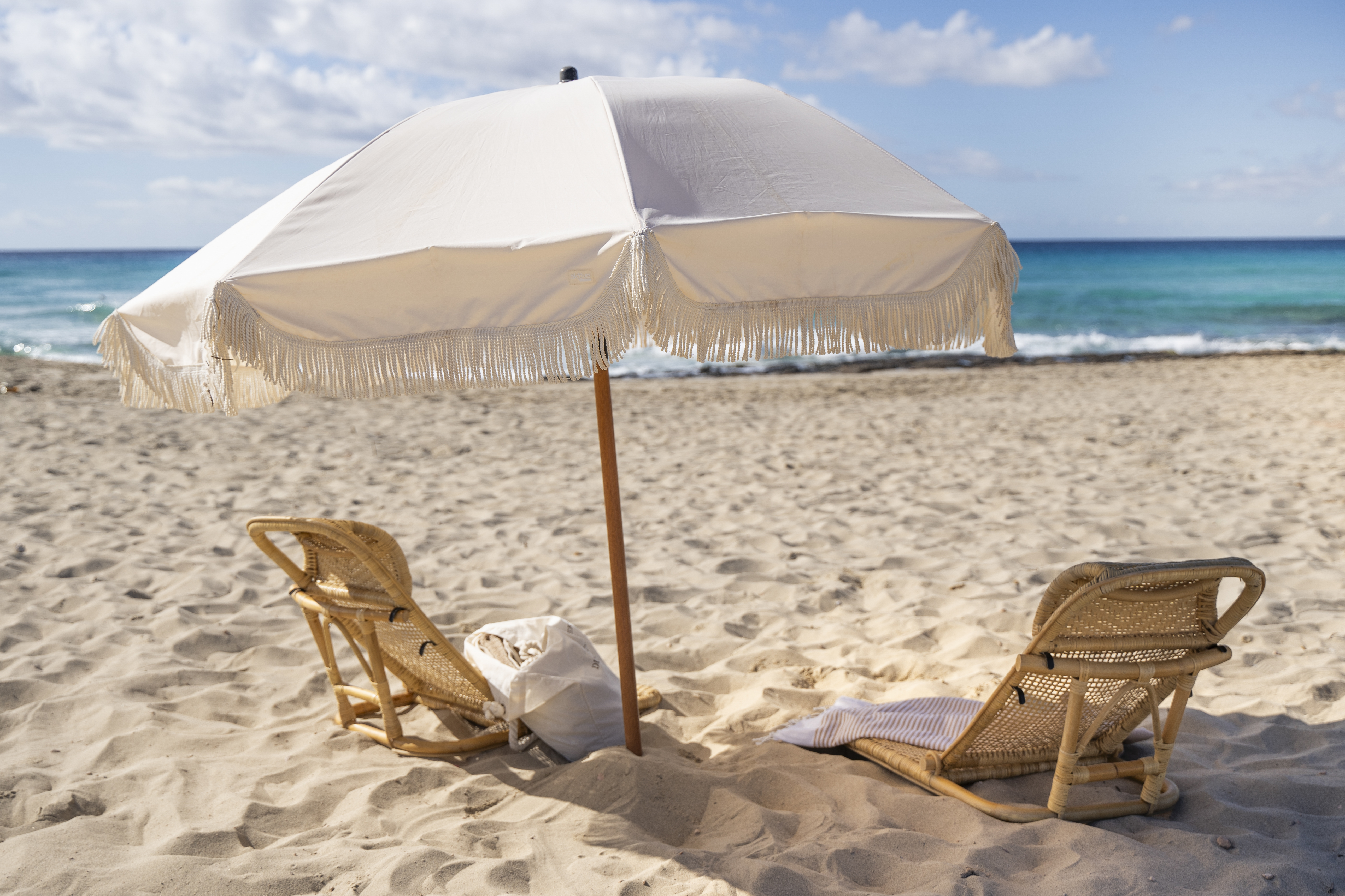 Dunas de Formentera beach, with pristine sands, calm turquoise sea and parasol and loungers