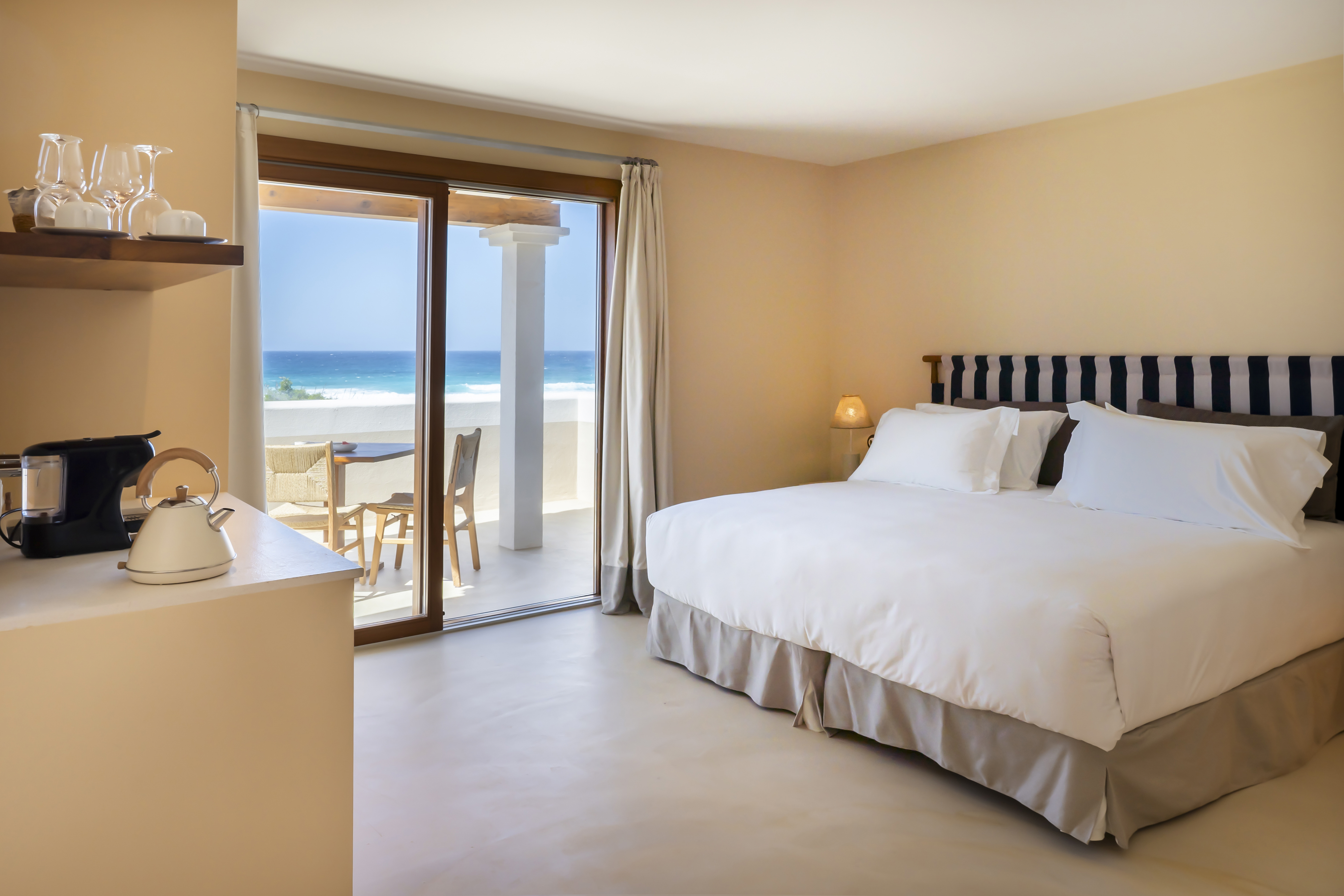 Dunas de Formentera Double Formentera room with large bed, kitchenette, and double doors onto a sea-facing terrace