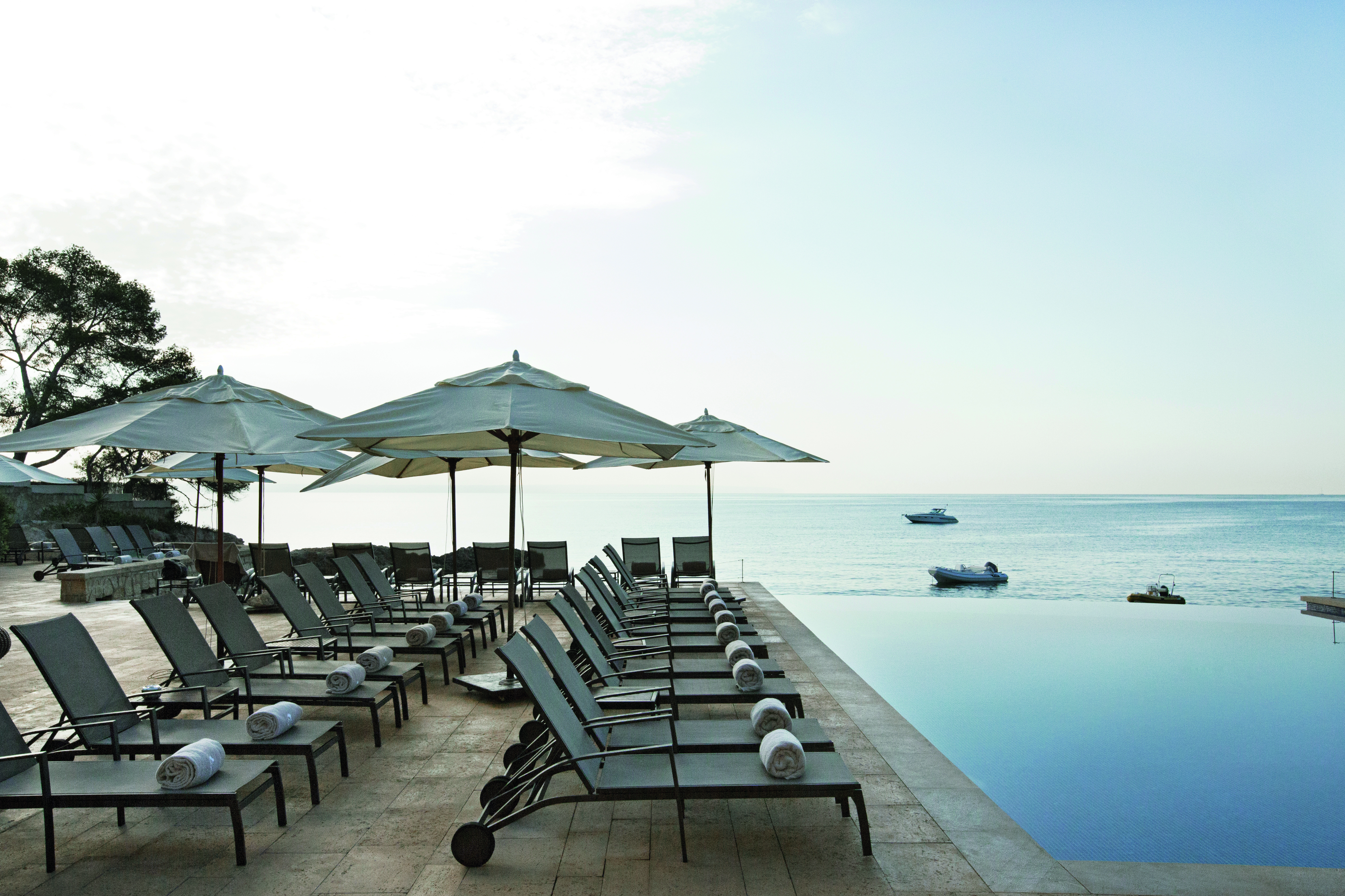 Hospes Maricel Mallorca poolside sun loungers infinity pool overlooking sea