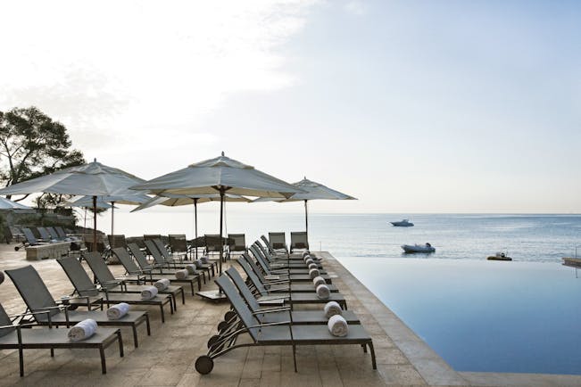 Hospes Maricel Mallorca poolside sun loungers infinity pool overlooking sea