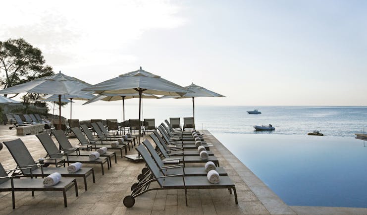 Hospes Maricel Mallorca poolside sun loungers infinity pool overlooking sea