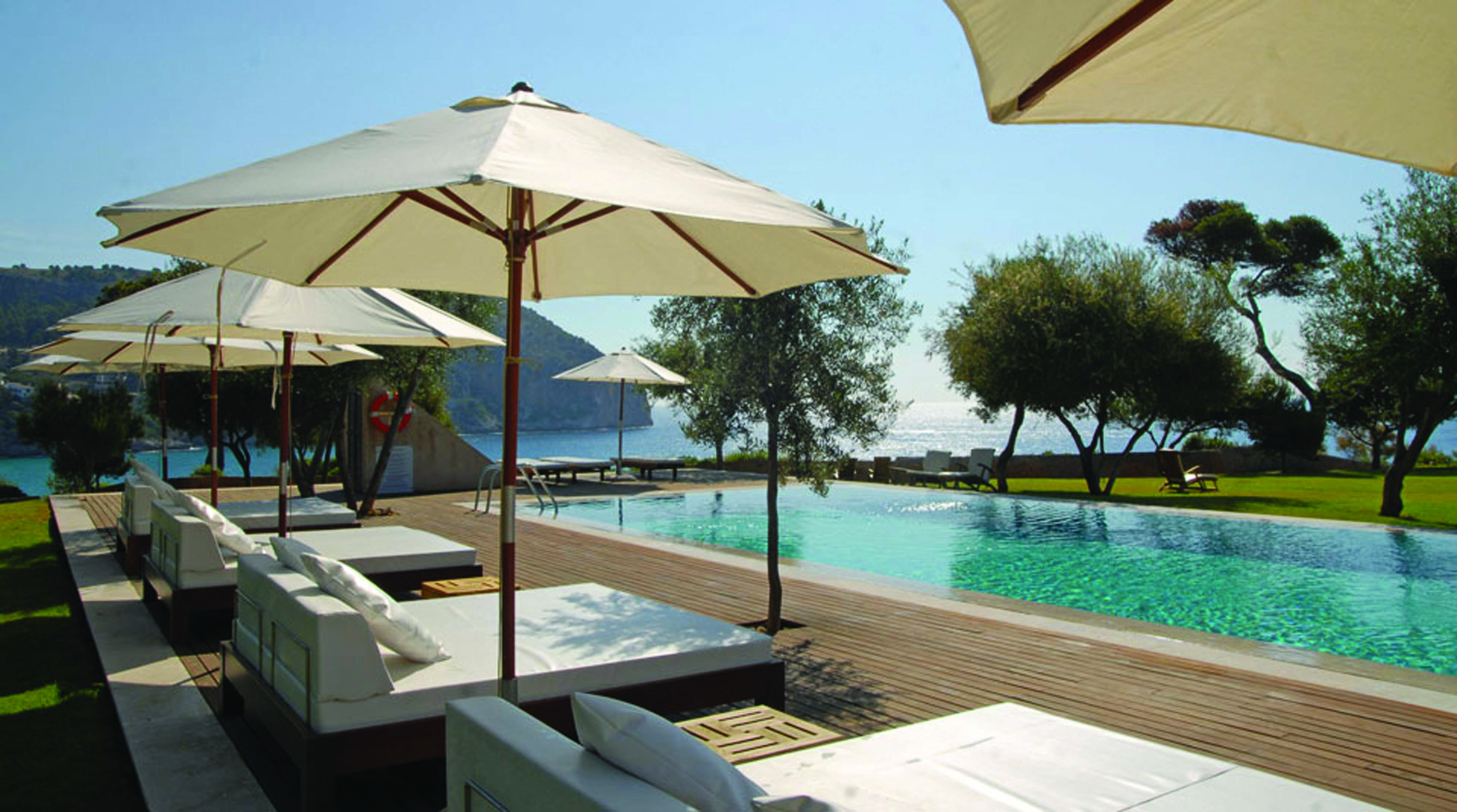 Can Simoneta Mallorca outdoor pool sun loungers umbrellas views of sea