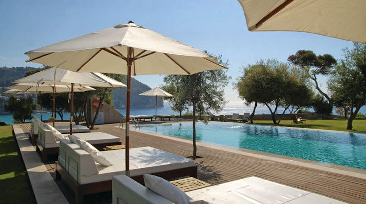 Can Simoneta Mallorca outdoor pool sun loungers umbrellas views of sea