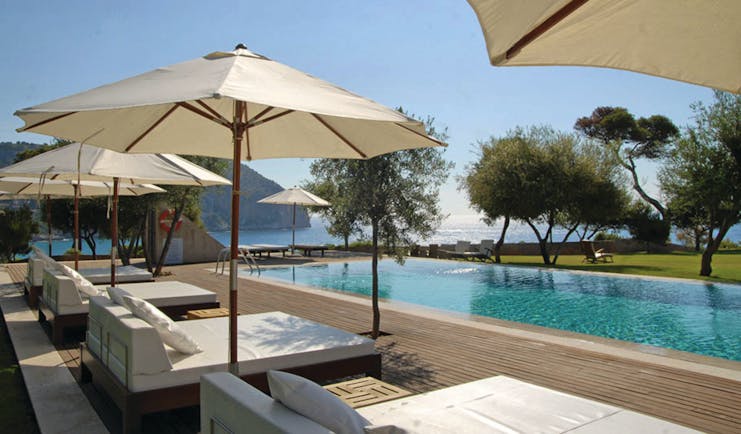 Can Simoneta Mallorca outdoor pool sun loungers umbrellas views of sea