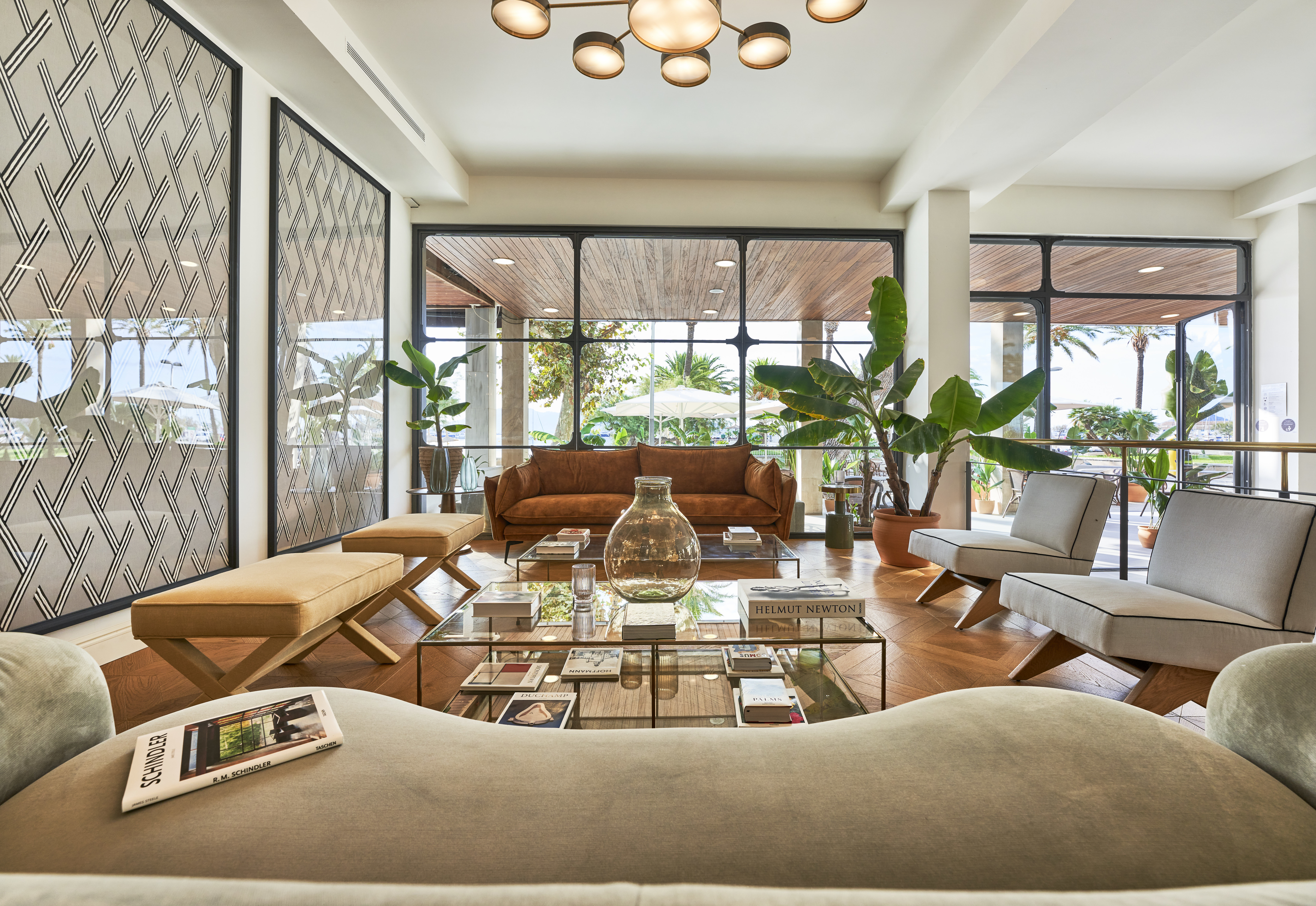 Hotel Hoposa Daina bar lounge area with comfortable sofas and floor-to-ceiling sea-view windows