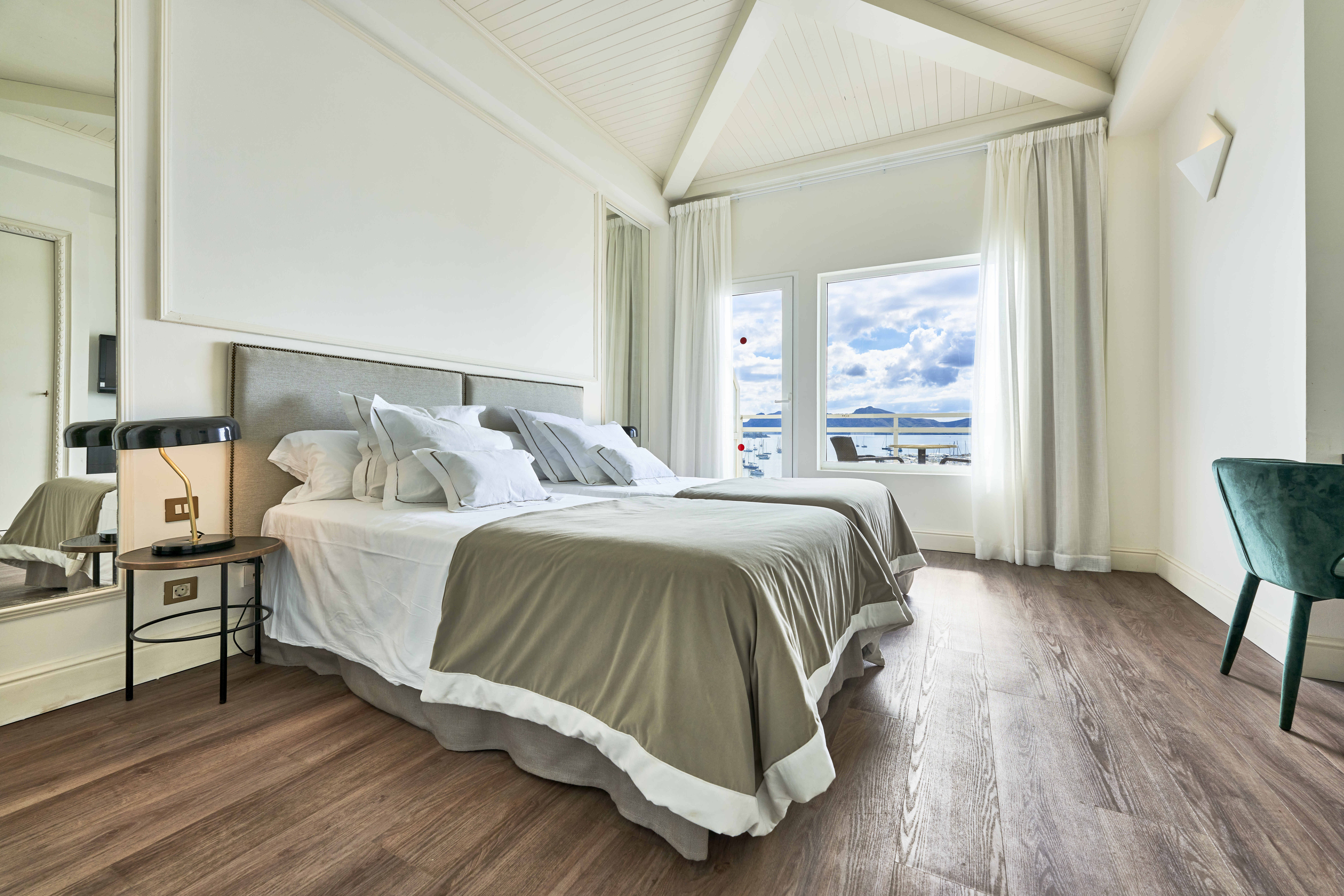 Hotel Hoposa Daina Sea View Room with large double bed, bright neutral colours, and views of the sea beyond