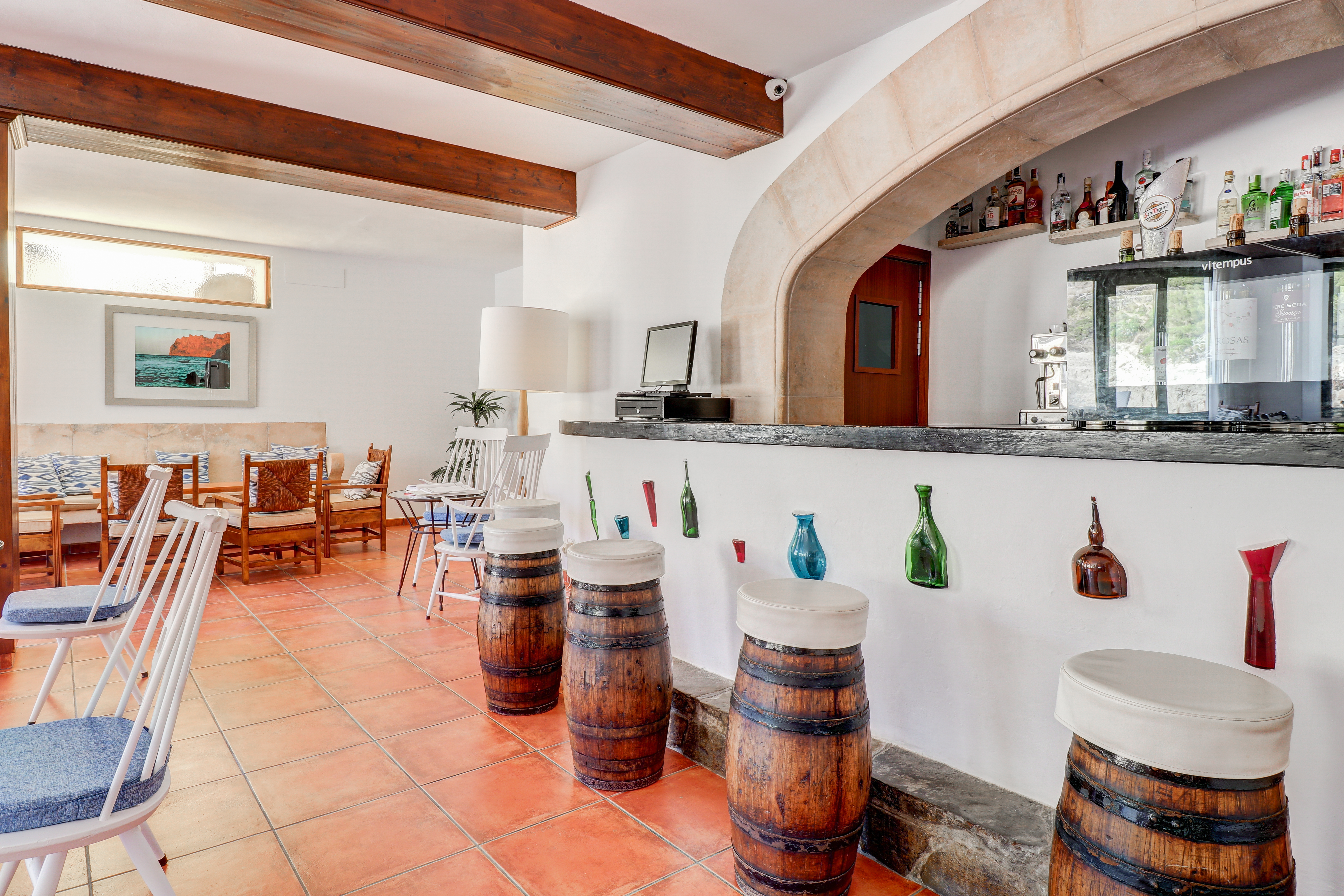 Hotel Hoposa Niu characterful bar with barrel stools and wooden beams