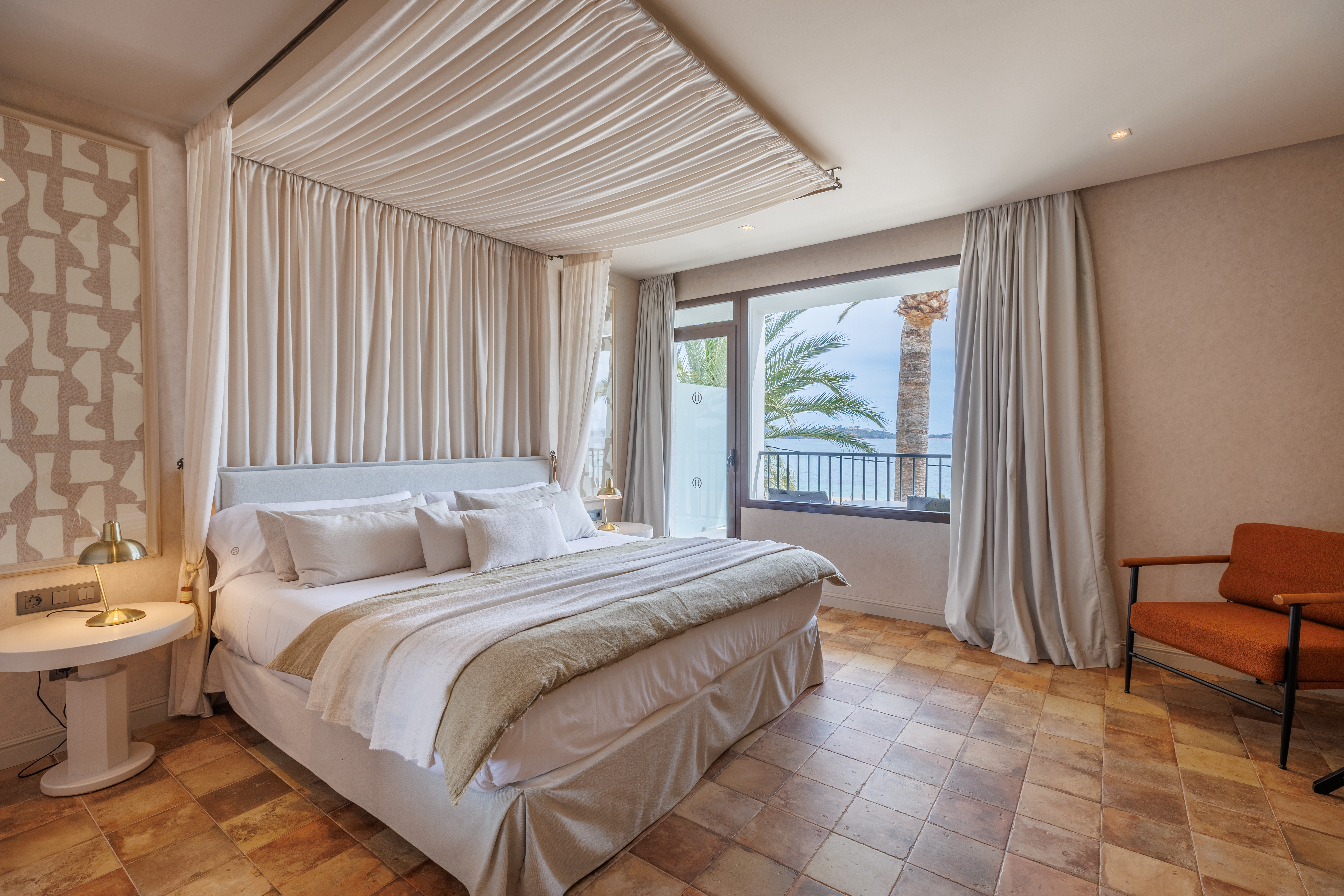 Hotel Hoposa Uyal Sea View Room, with elegant neutral decor, tiled floor, and views out across palm trees and the sea