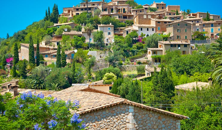 Hill-top village of Deia with its stone houses, olive trees and cypress trees in Mallorca