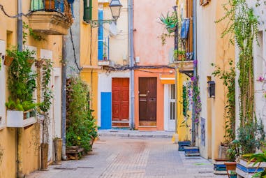 Colourful houses in alley with no cars and plants and balconies in Palma Mallorca