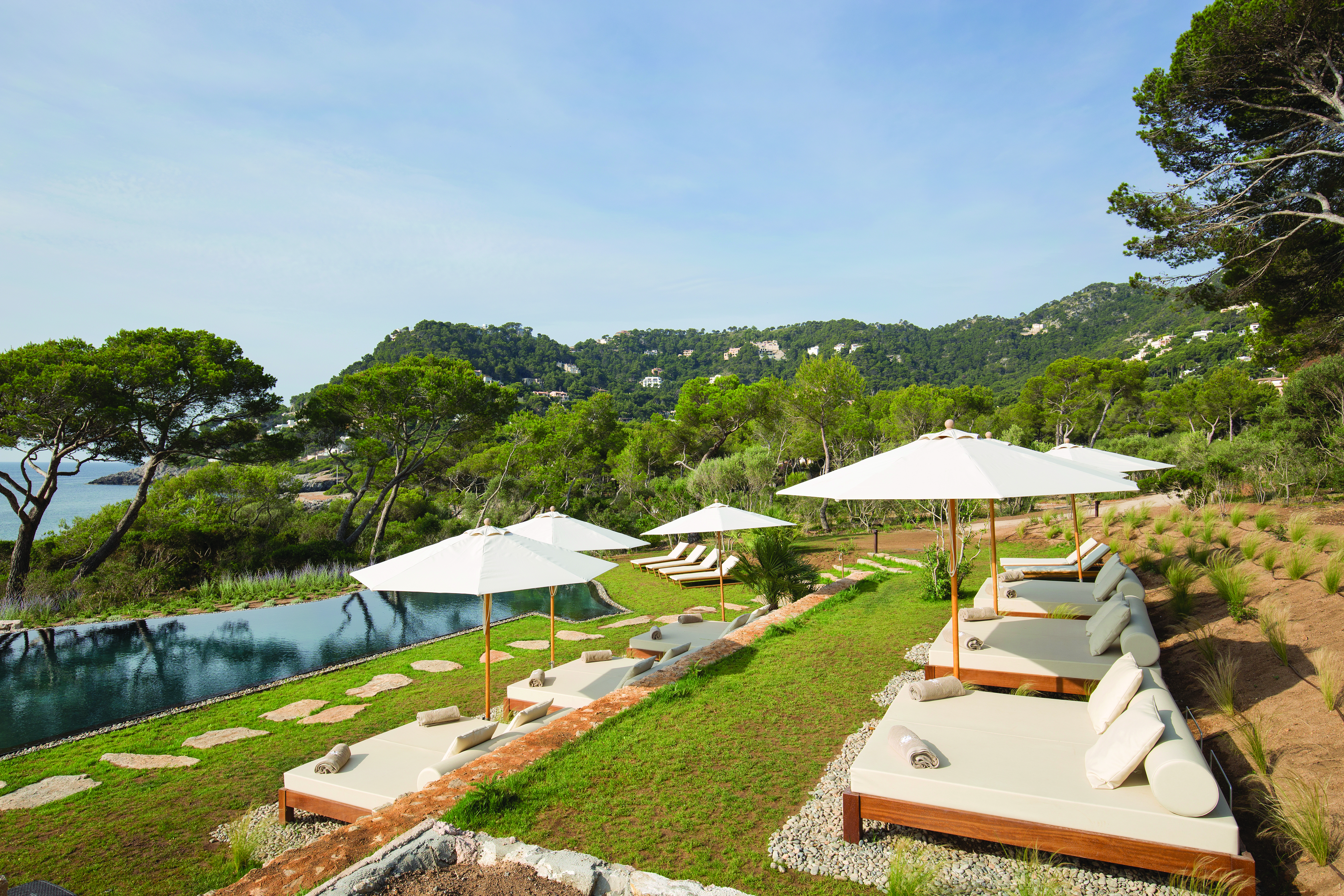 Pleta de Mar Mallorca infinity poolside sun loungers umbrellas overlooking sea