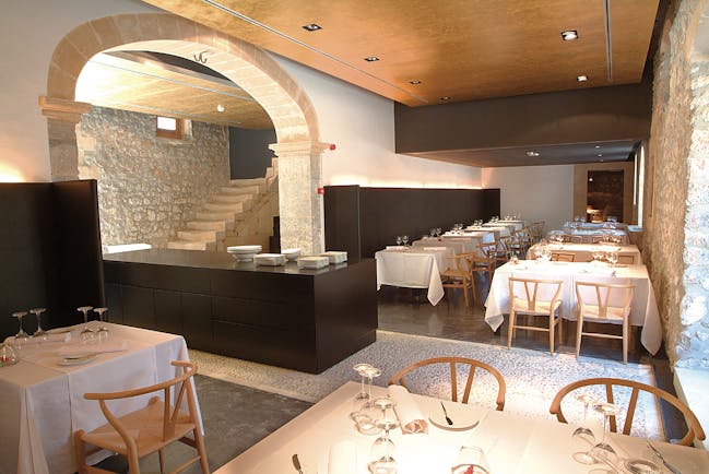 Son Brull Mallorca restaurant indoor dining area stone walls modern décor