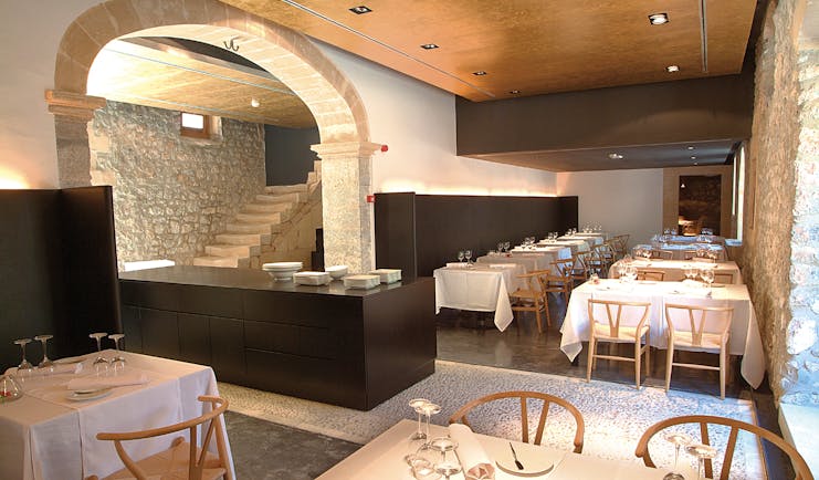 Son Brull Mallorca restaurant indoor dining area stone walls modern décor