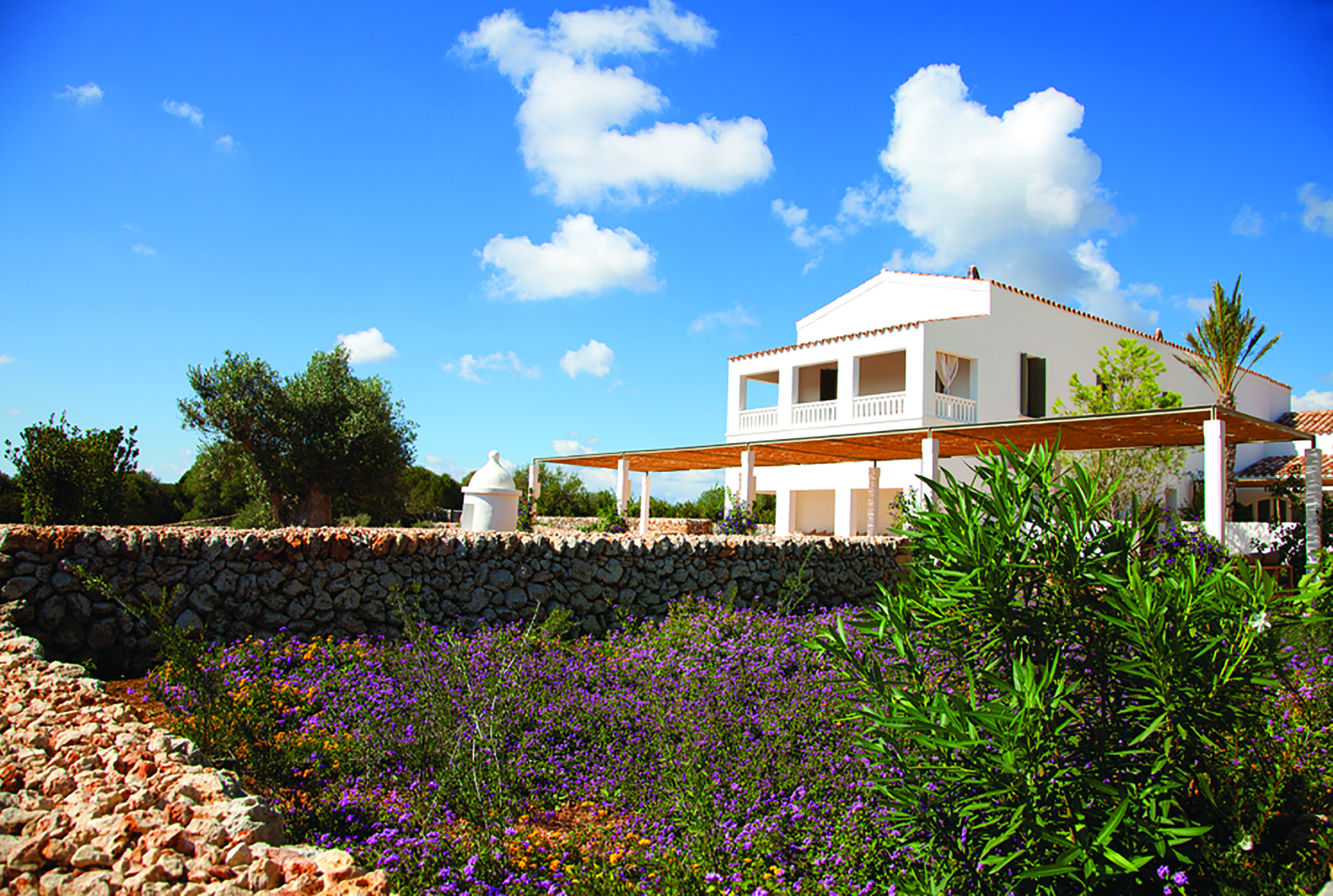 Torralbenc Menorca exterior hotel building flowers trees