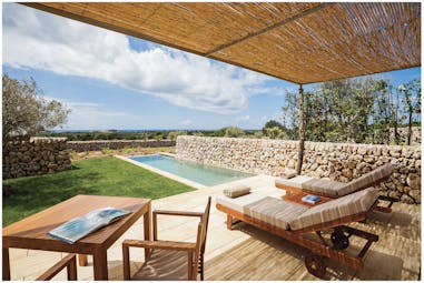 Torralbenc Menorca pool cottage terrace pool sun loungers lawn sea in background