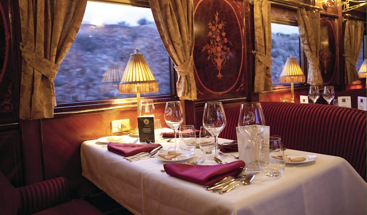 Dining table laid for meal in train carriage