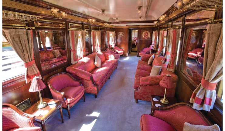Red sofas and chairs in train carriage