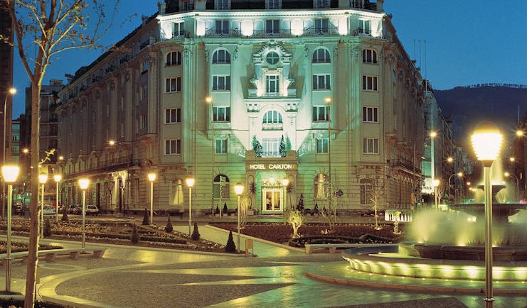 Hotel Carlton Bilbao exterior lit up at night view from street