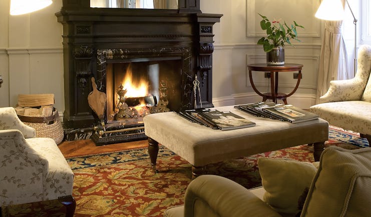 Villa Soro Basque sitting room armchairs open fire elegant décor