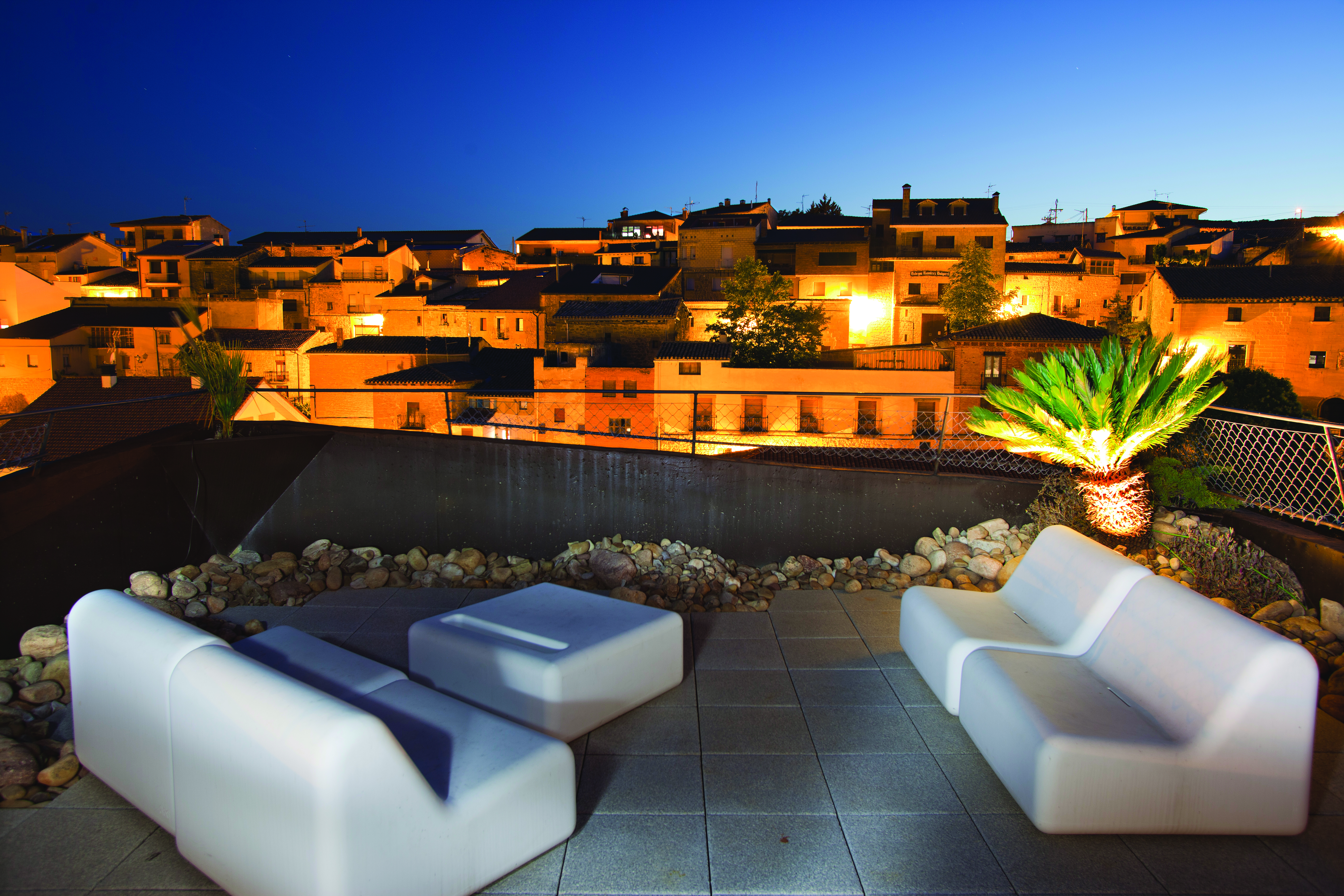 Hotel Viura Basque rooftop terrace at night outdoor seating area overlooking the city