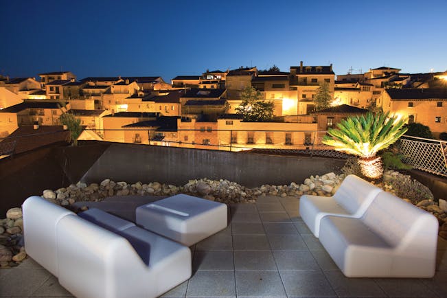 Hotel Viura Basque rooftop terrace at night outdoor seating area overlooking the city
