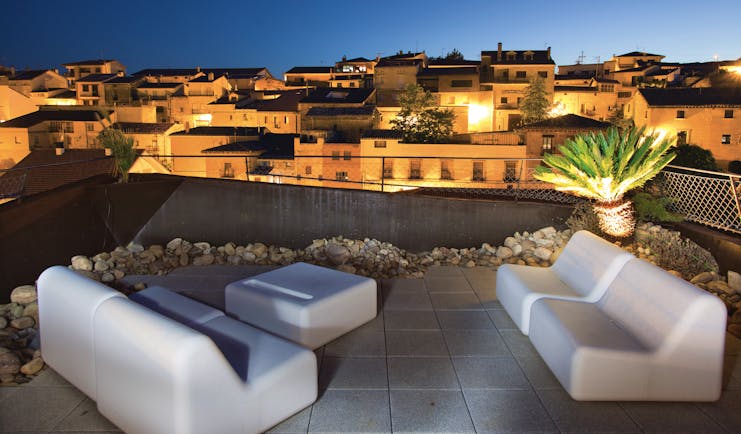 Hotel Viura Basque rooftop terrace at night outdoor seating area overlooking the city