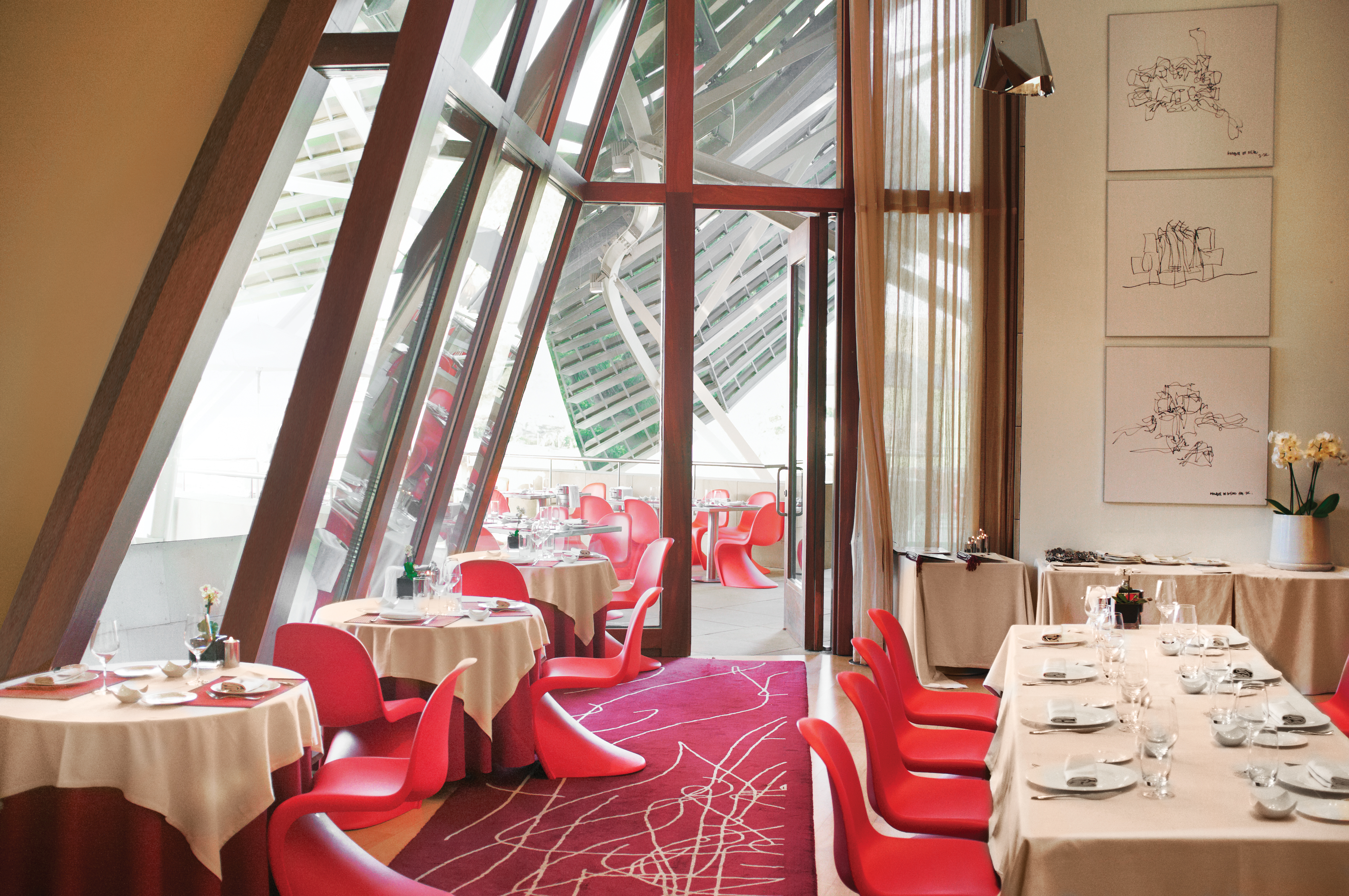 Restaurant with dining table set up with chairs in a window pannelled room 