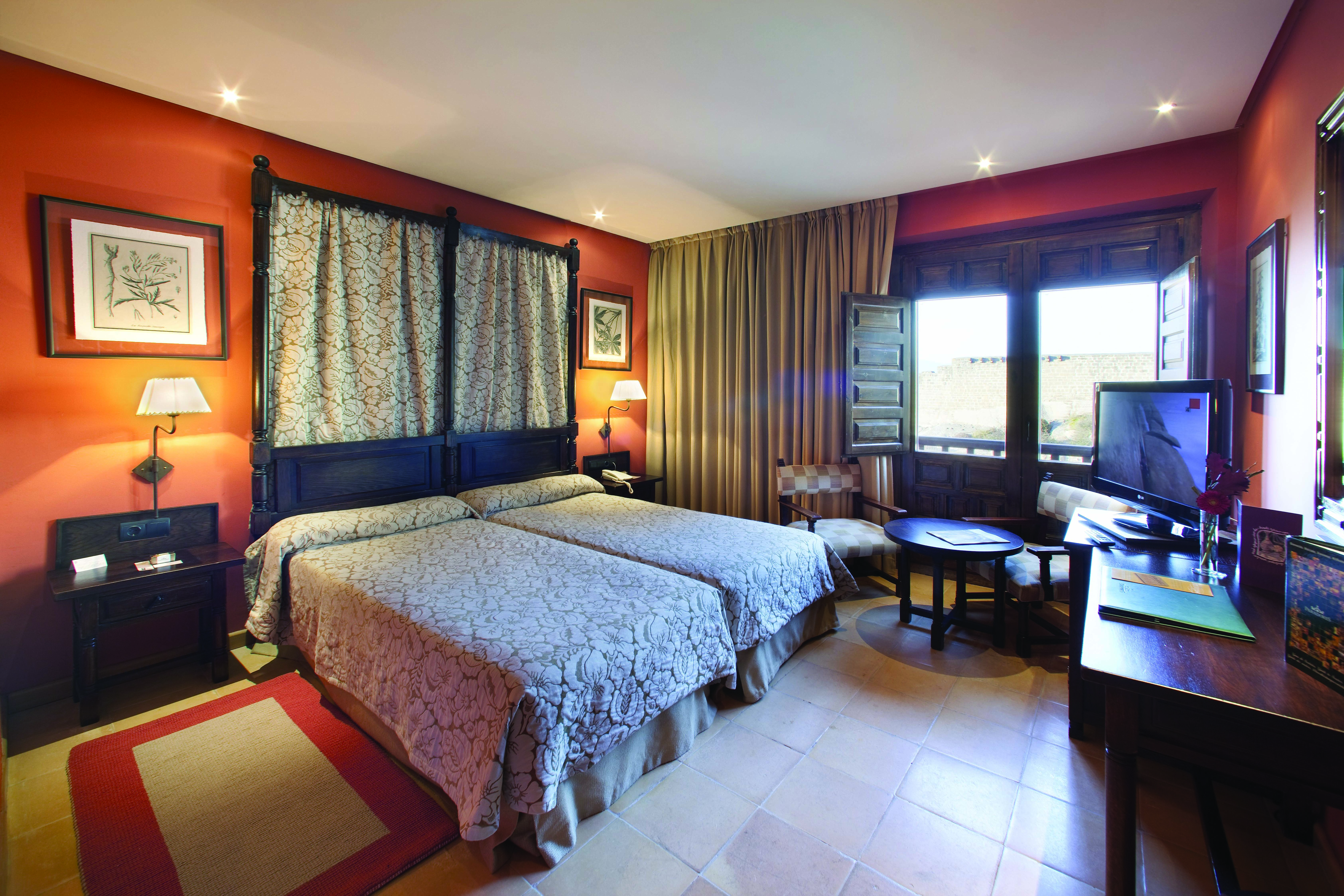 Parador de Sos del Rey Catalico Basque guestroom bed seating traditional Castilian décor