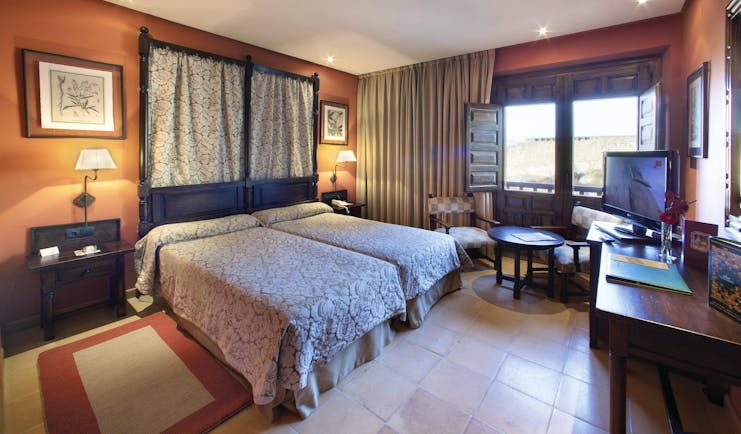 Parador de Sos del Rey Catalico Basque guestroom bed seating traditional Castilian décor