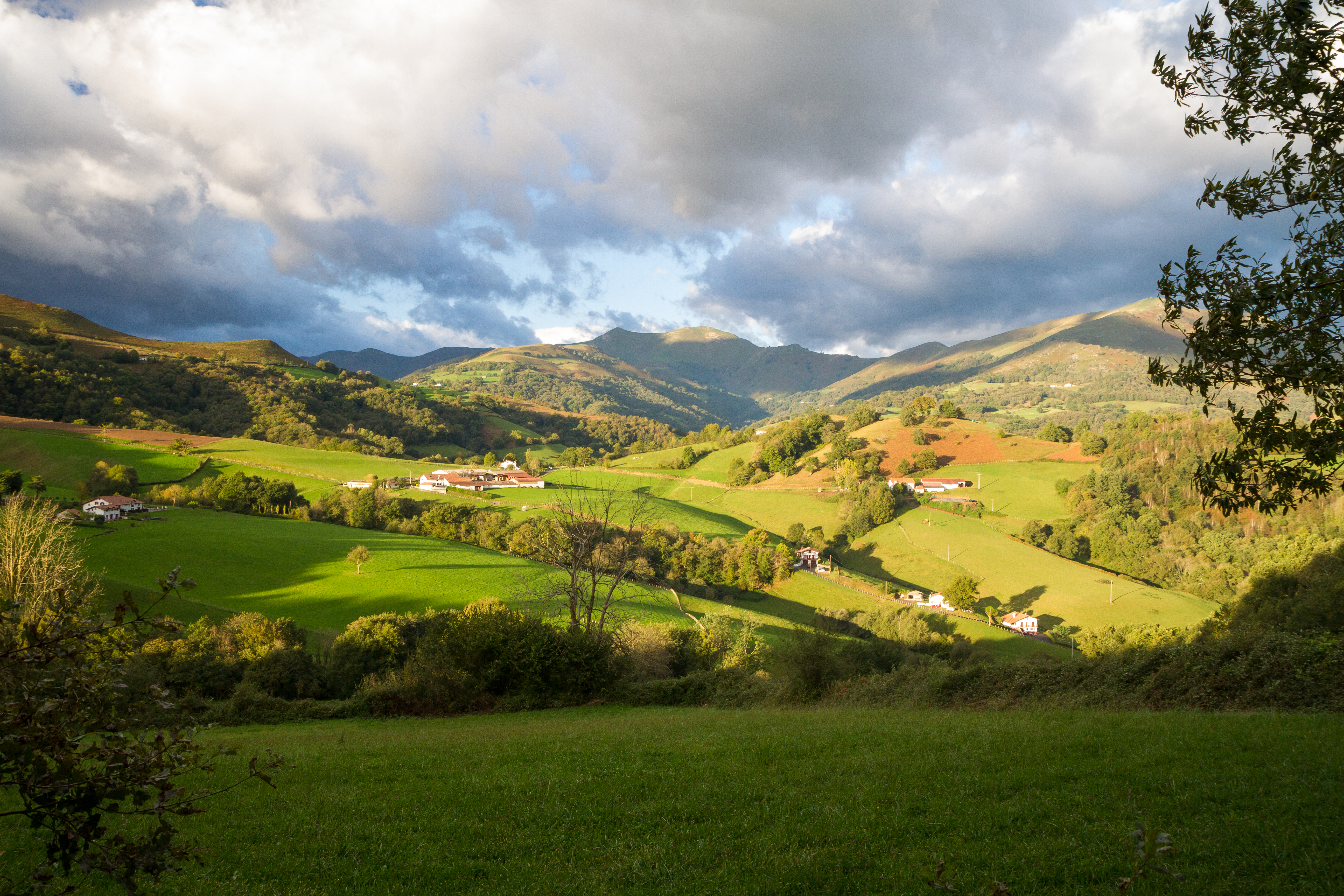 Rolling hills with cloudy sky and shadow in the foothills of the Pyrenees in Spanish Basque country