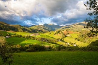 Rolling hills with cloudy sky and shadow in the foothills of the Pyrenees in Spanish Basque country
