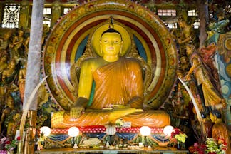 Gangaramaya Temple in Colombo, colourful Buddha statue with lights and colourful details