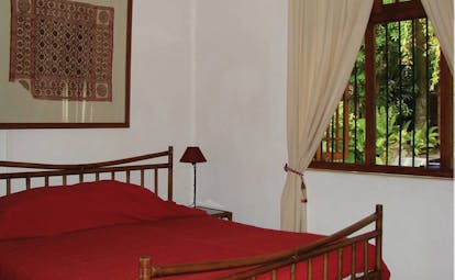 Havelock Place Bungalow Sri Lanka red bedroom traditional artwork