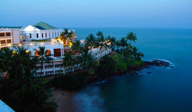 Mount Lavinia Hotel Sri Lanka aerial view day white hotel coast palm trees