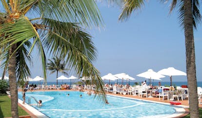 Mount Lavinia Hotel Sri Lanka poolside outdoor pool with sun loungers umbrellas and palm trees