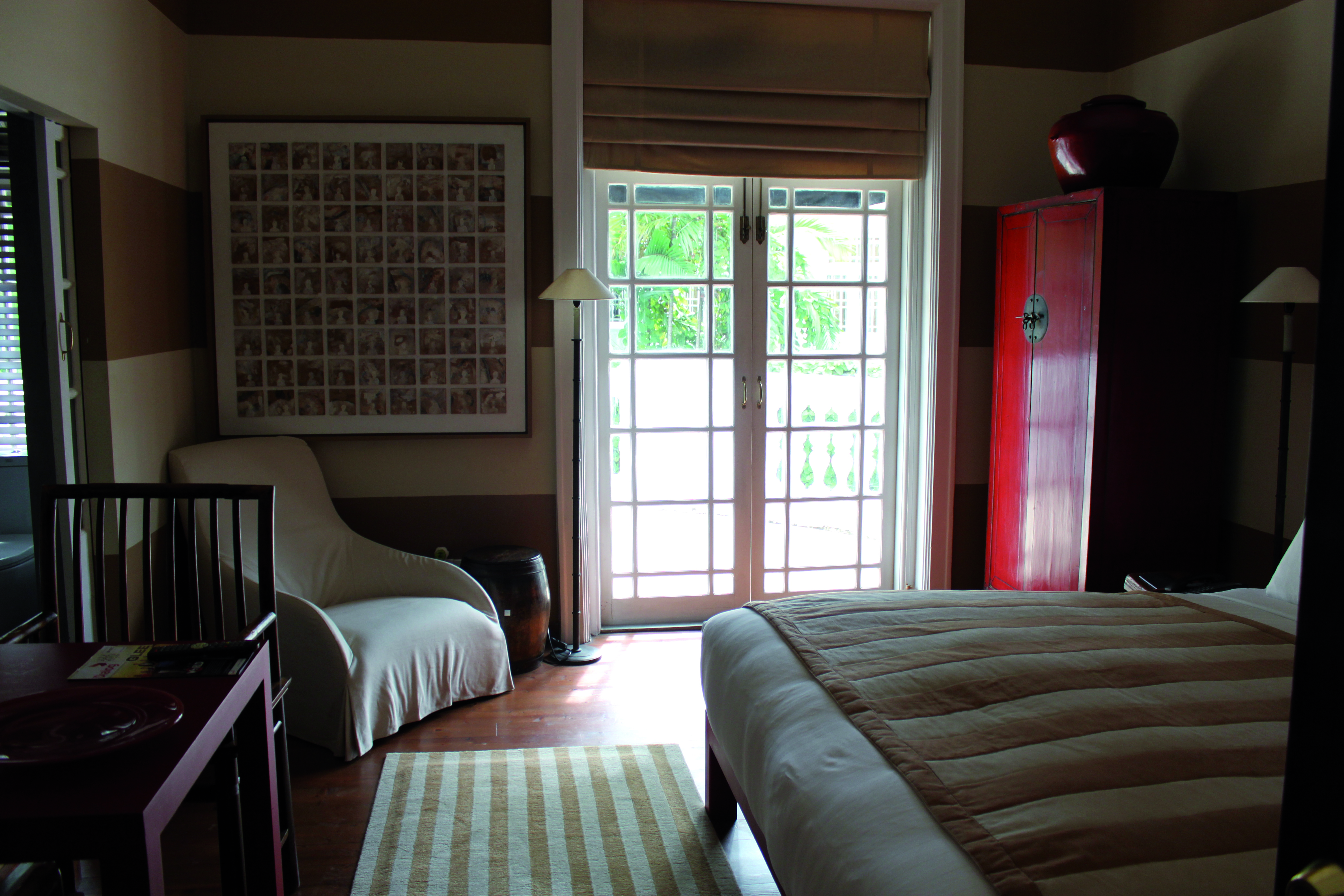 Paradise Road Tintagel guestroom, double bed, chair, colourful traditional style decor