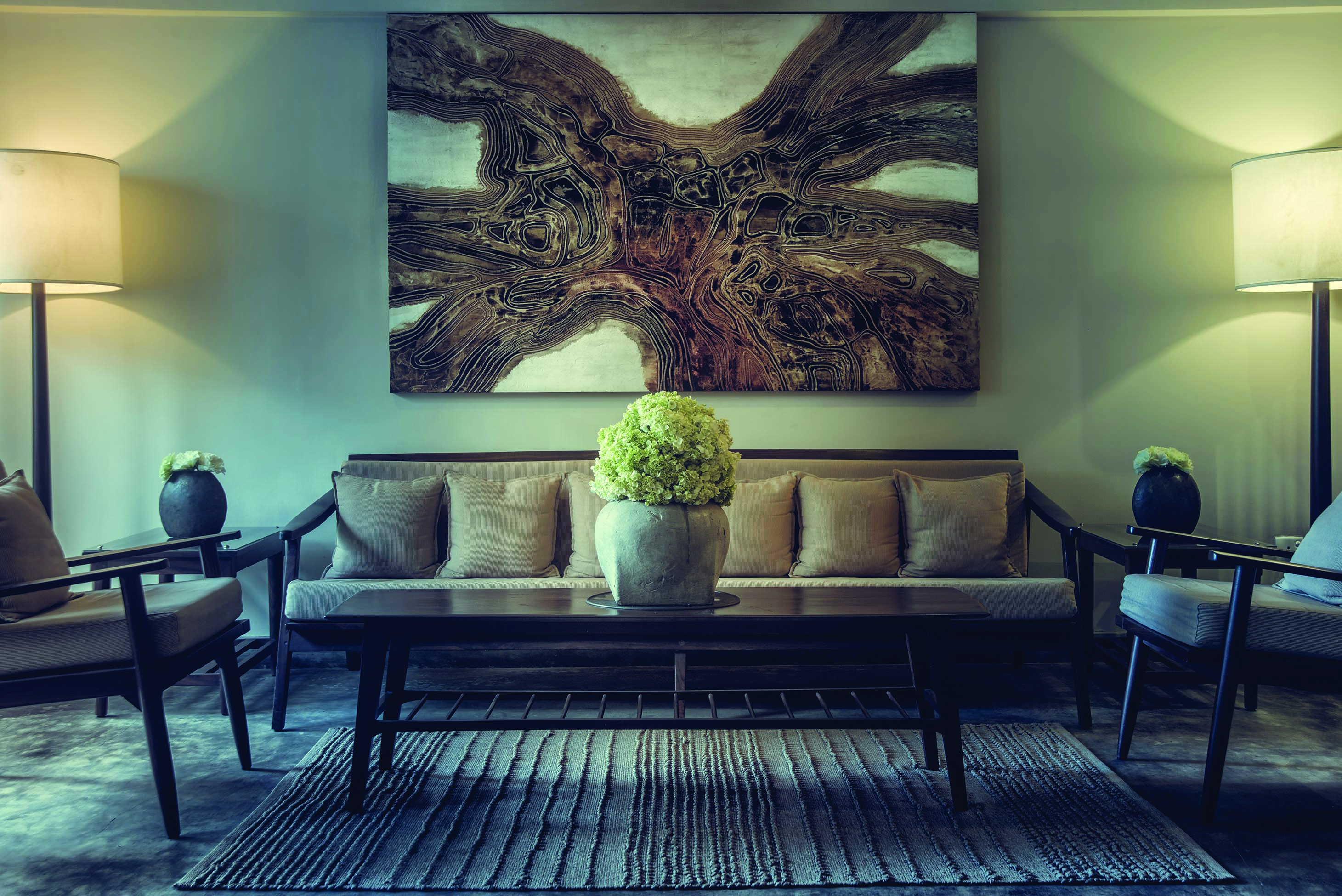 Ground floor sitting area with large painting on the wall and sofa