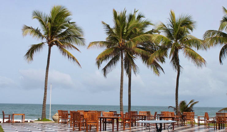 Galle Face Hotel Sri Lanka Chessboard outdoor dining area with palm trees and chequerboard tiled floor