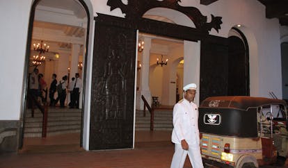 Galle Face Hotel Sri Lanka entrance carved door vintage car and uniformed driver