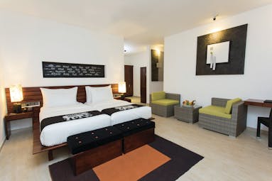 Aliya Sri Lanka deluxe twin room bed armchairs bright modern décor