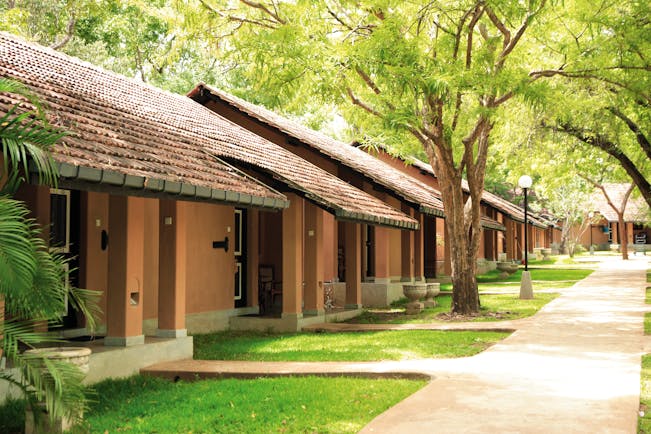 Chaaya Village Sri Lanka cottages exterior pathway lawns trees