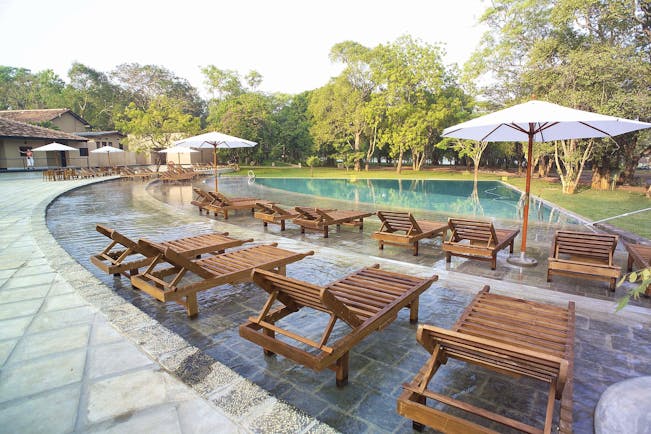 Chaaya Village Sri Lanka pool terrace sun loungers umbrellas