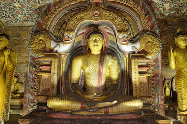 Rock Temple of Dambulla, Buddha shrine, large colourful statue, intricate carvings